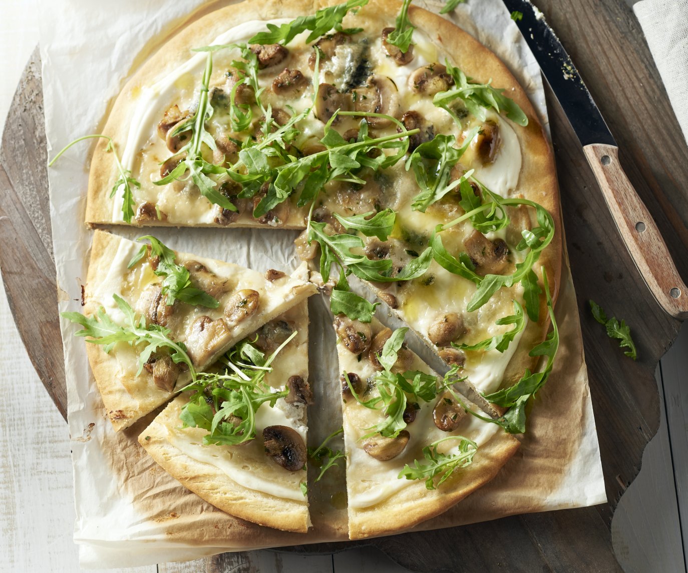 Witte pizza met champignons, roquefort en rucola